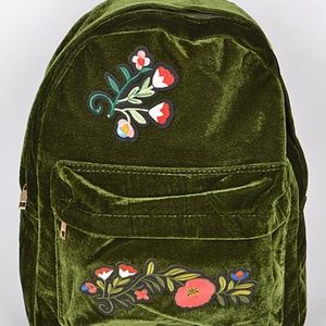 Green velvet backpack with appliqué